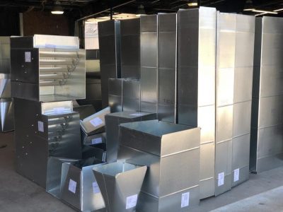 Galvanized ductwork components staged for installation.