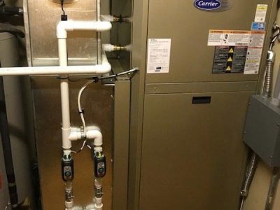 Professional gas furnace installation in a utility space.