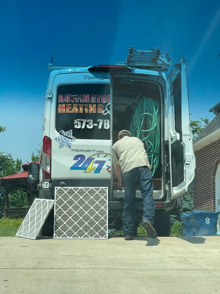 Buffington Brothers technician working out of a branded Transit service van on a residential filter change call.
