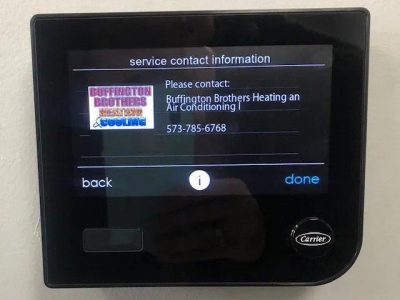 Carrier smart thermostat displaying Buffington Brothers Heating and Cooling contact information.