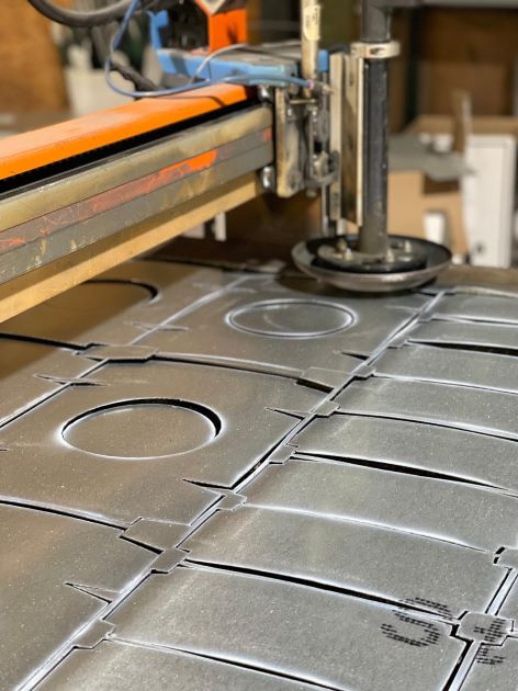 CNC plasma cutting table in the Buffington Brothers shop cutting custom sheet-metal duct fittings.